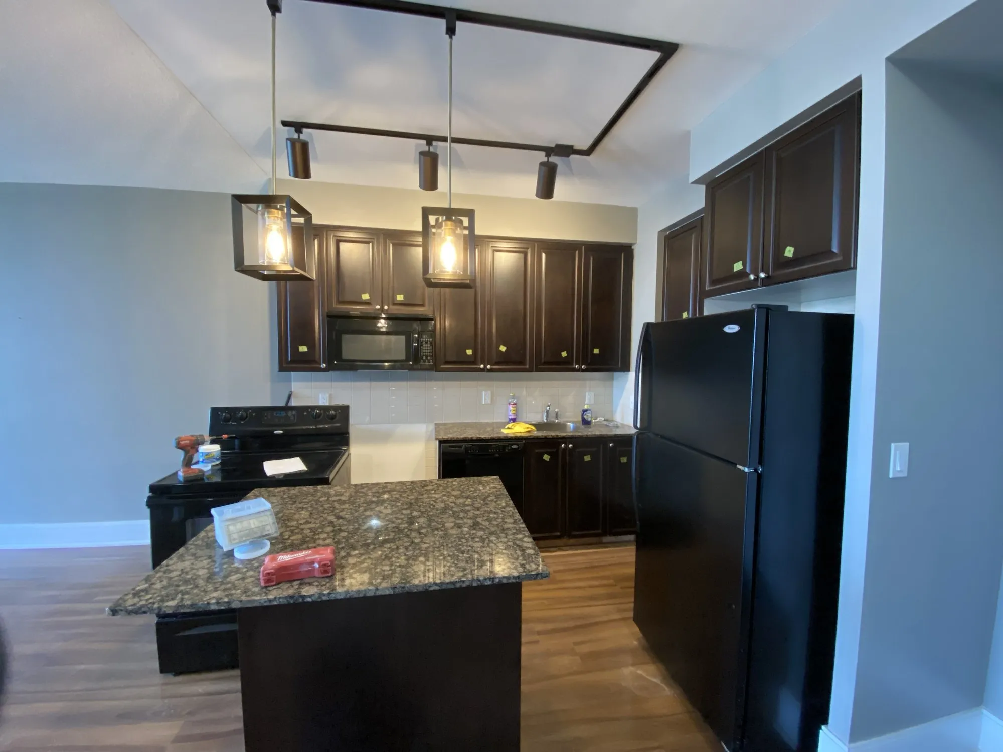 Before — espresso repainted cream, island extended and finished in a second colour — City Centre, Mississauga