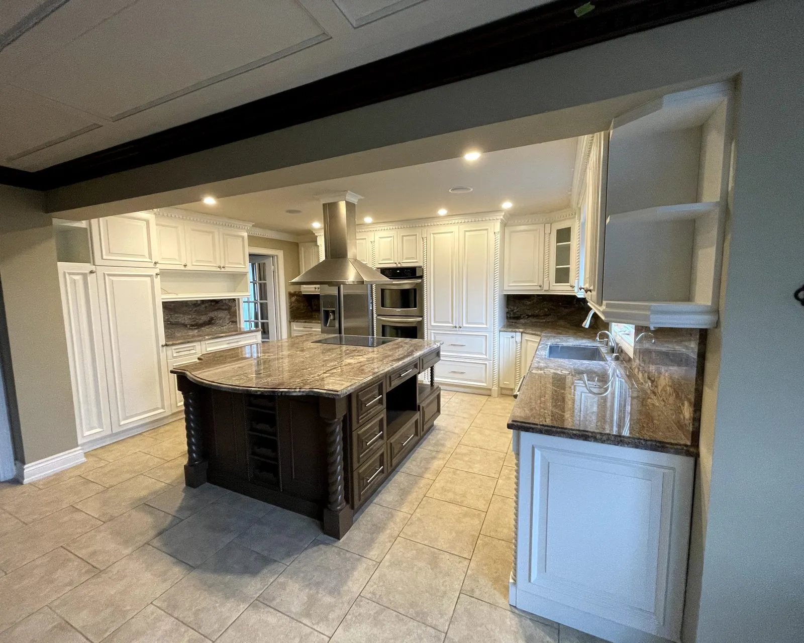 After — espresso perimeter sprayed cream, island a contrasting dark tone, granite and backsplash kept — East Credit, Mississauga