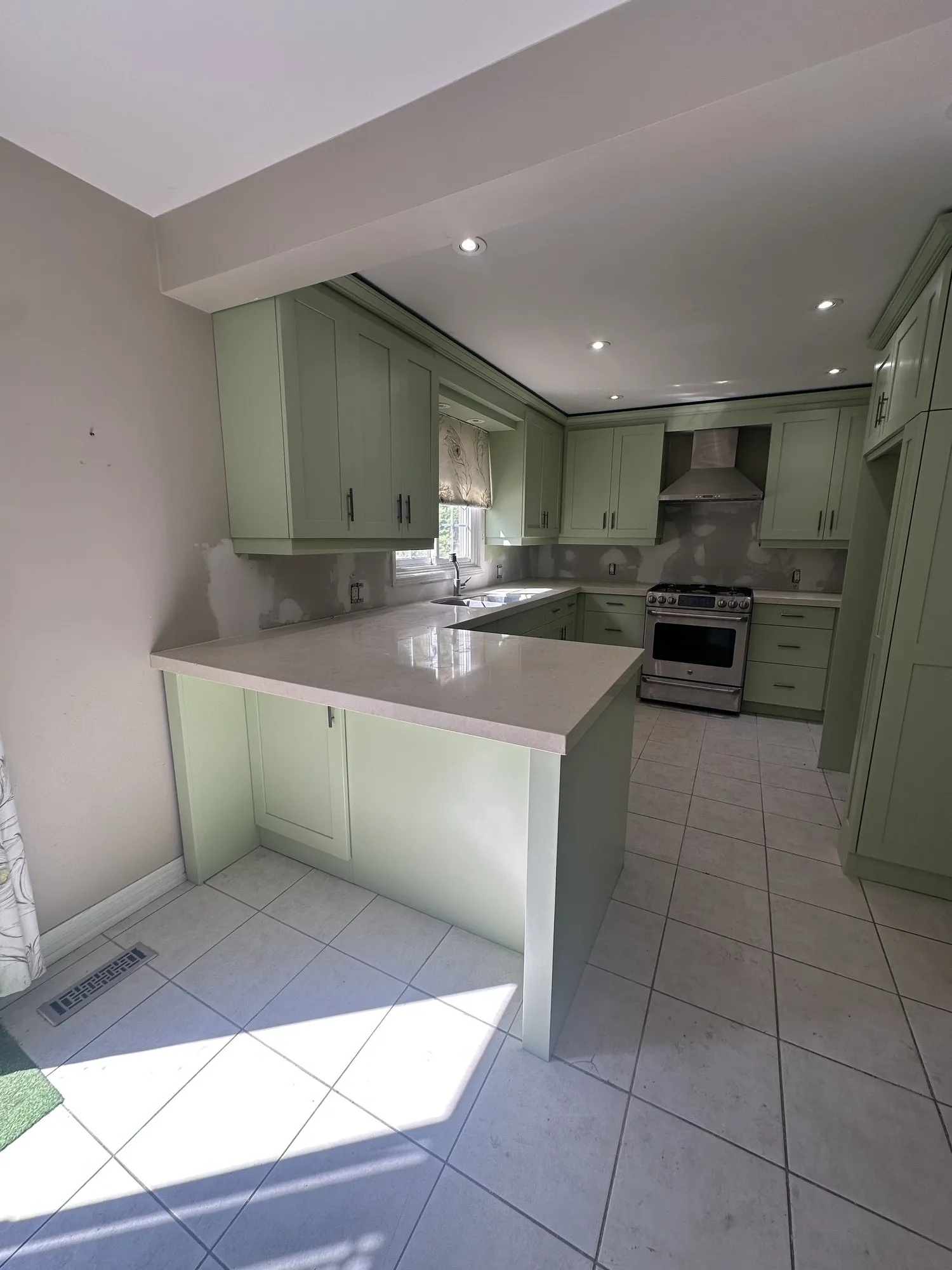 After — espresso sprayed a light green, new handles, cabinets only — Erin Mills, Mississauga