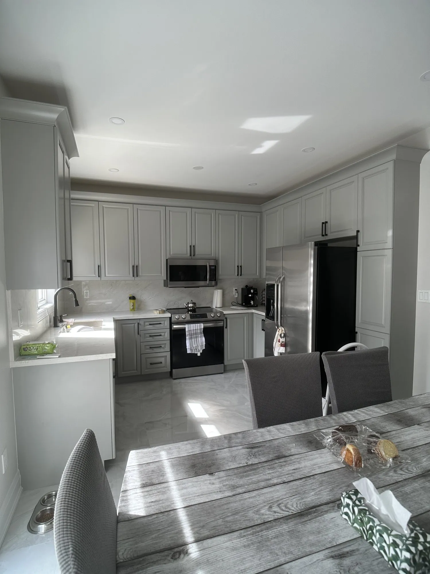 After — oak sprayed Platinum Gray, crown moulding added, matte black handles — Vellore Village, Vaughan