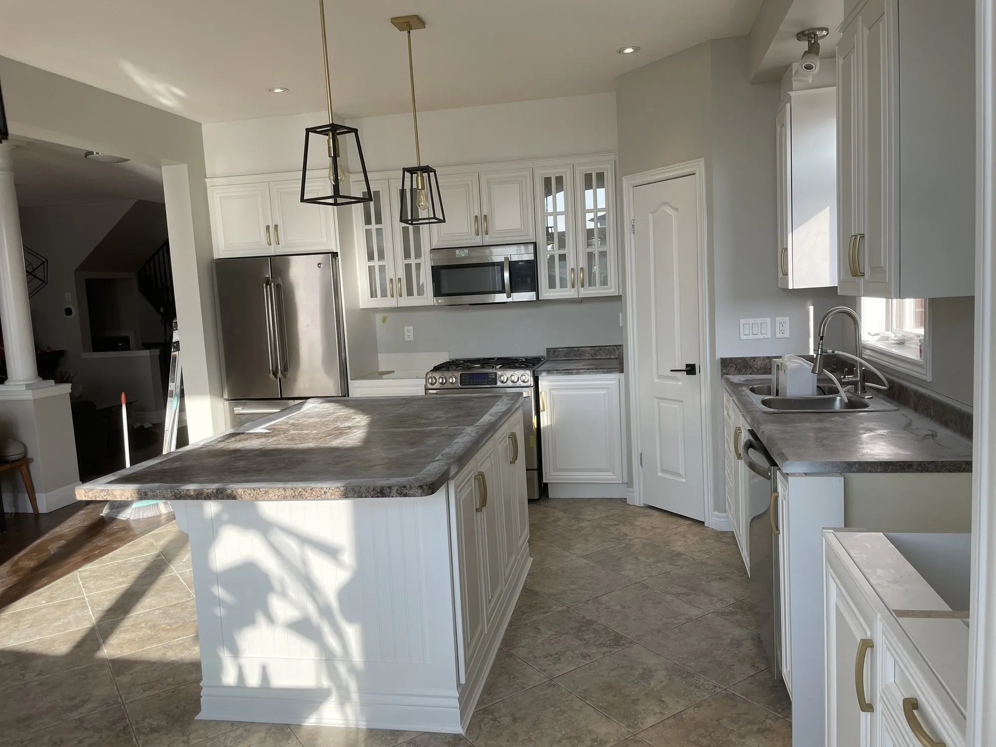 After — cream cabinetry refinished white, counters and layout kept — Stoney Creek, Hamilton