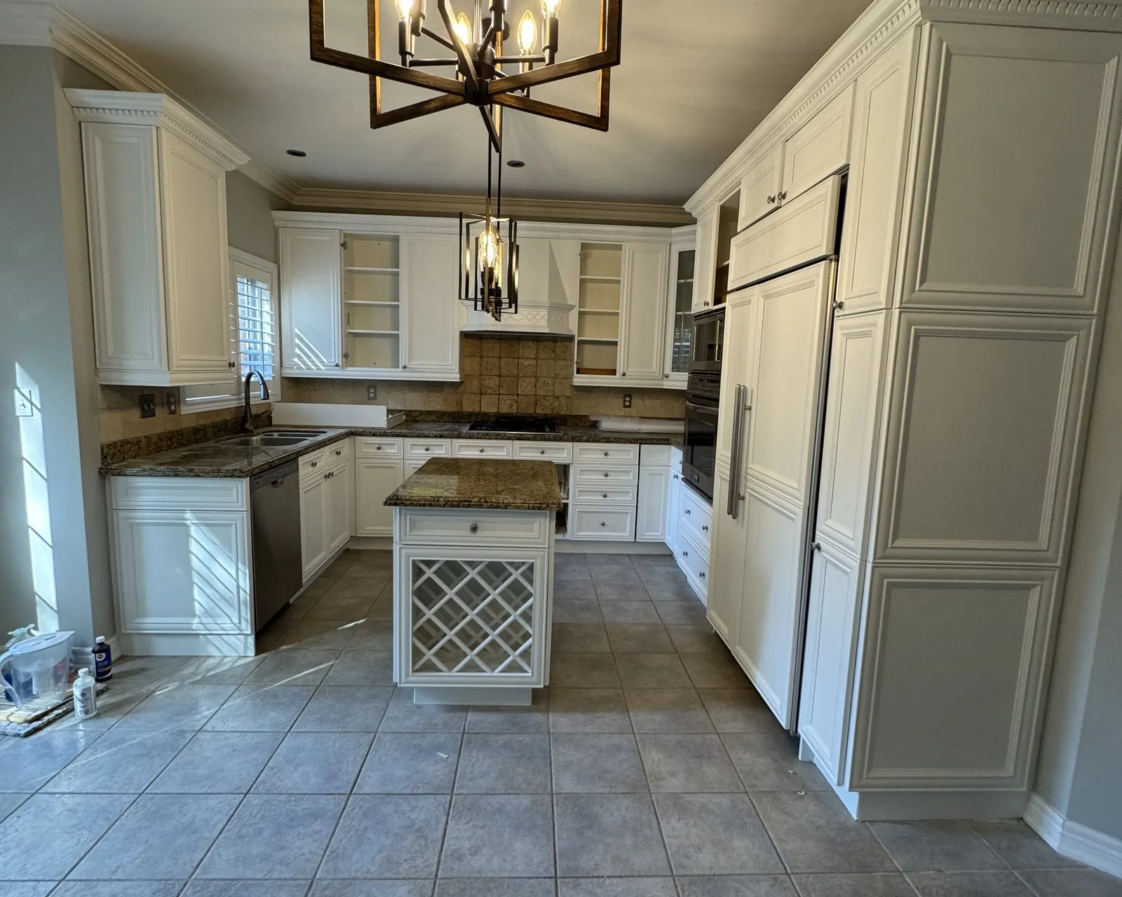 After — antiqued cream sprayed bright white, granite kept — Clearview, Oakville