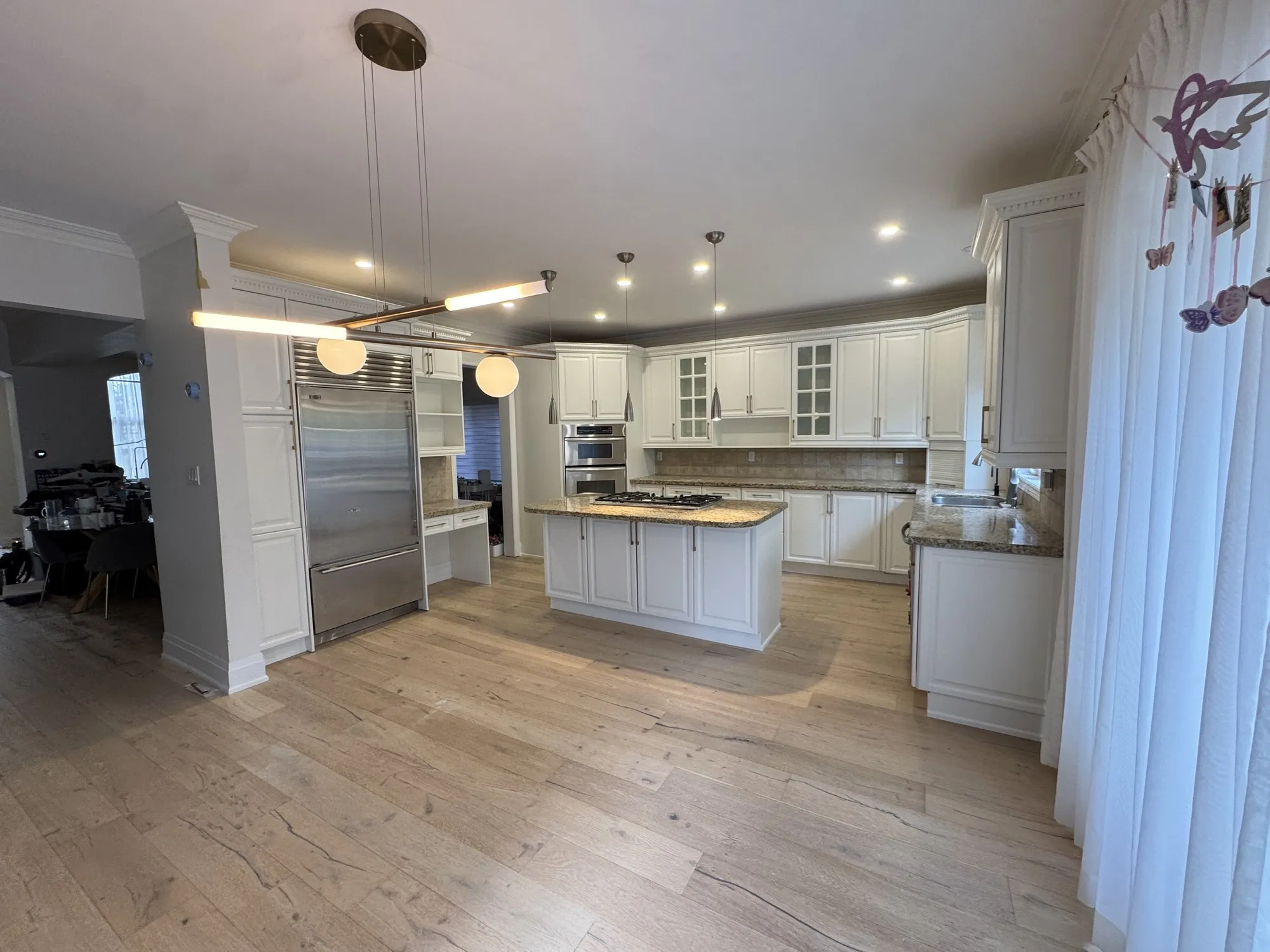 After — dark espresso sprayed Cloud White, kitchen and master vanity — Joshua Creek, Oakville