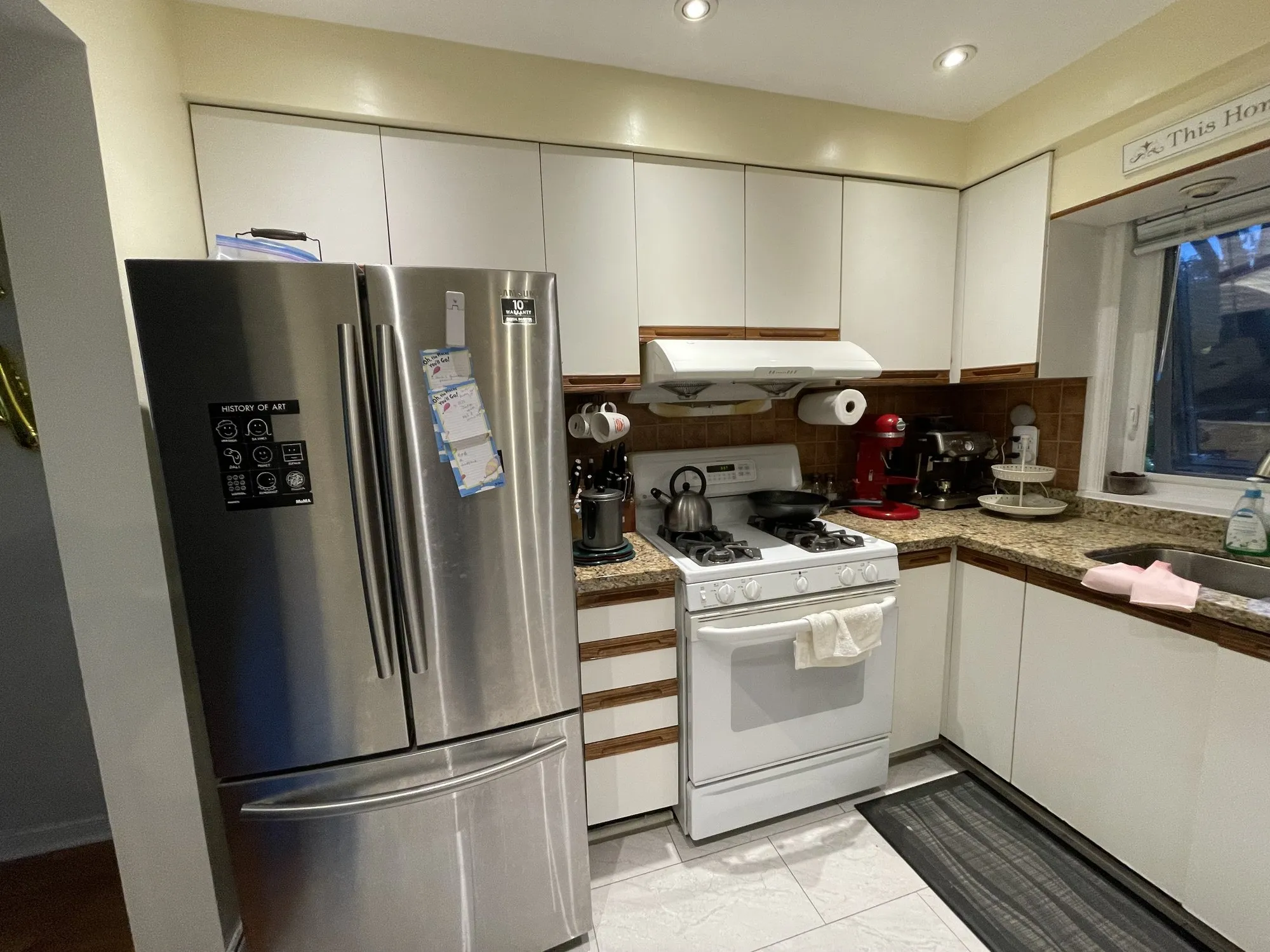 Before — flat white doors refaced with MDF shaker fronts, granite and layout kept — Erindale, Mississauga