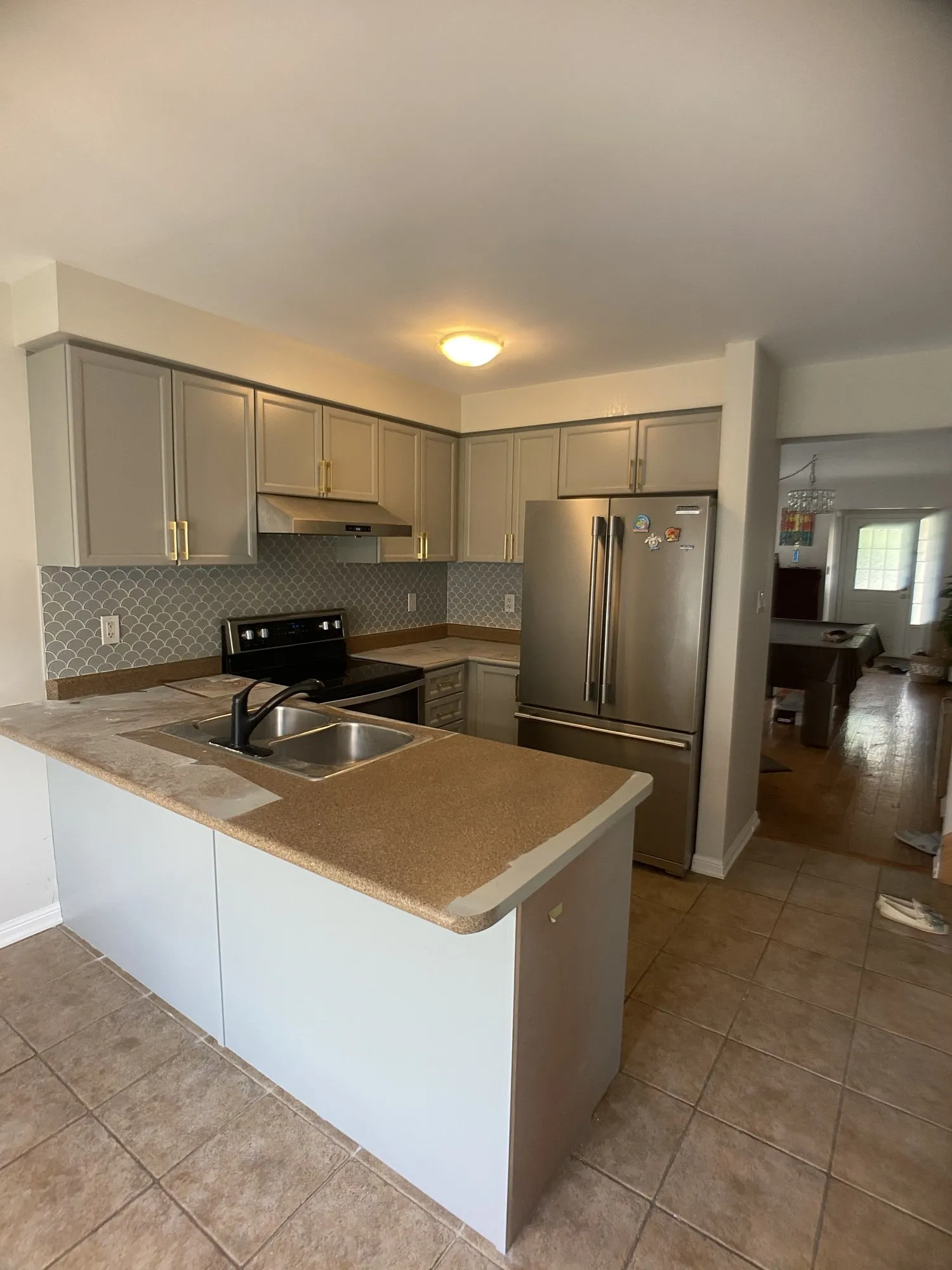 After — honey oak refinished light grey, counters and backsplash kept — West Oak Trails, Oakville