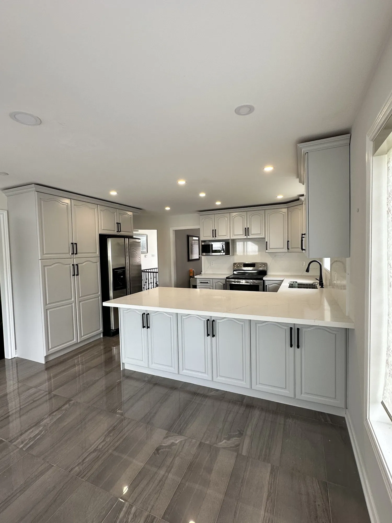 After — walnut refinished white, nine glass doors replaced with solid MDF — Rouge Woods, Richmond Hill