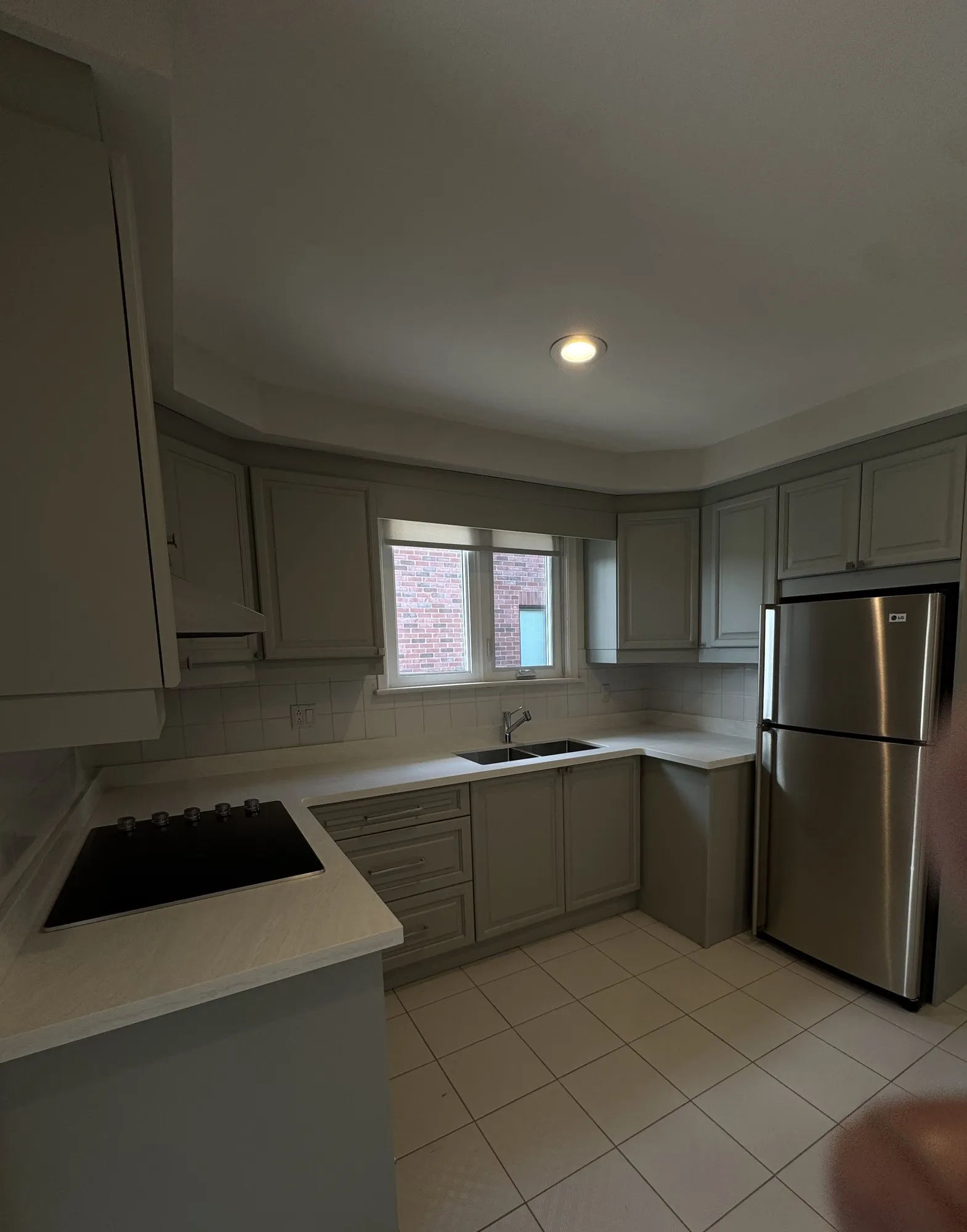 After — dark walnut sprayed one grey tone, three cabinets rebuilt in Pelmo Park-Humberlea, Toronto