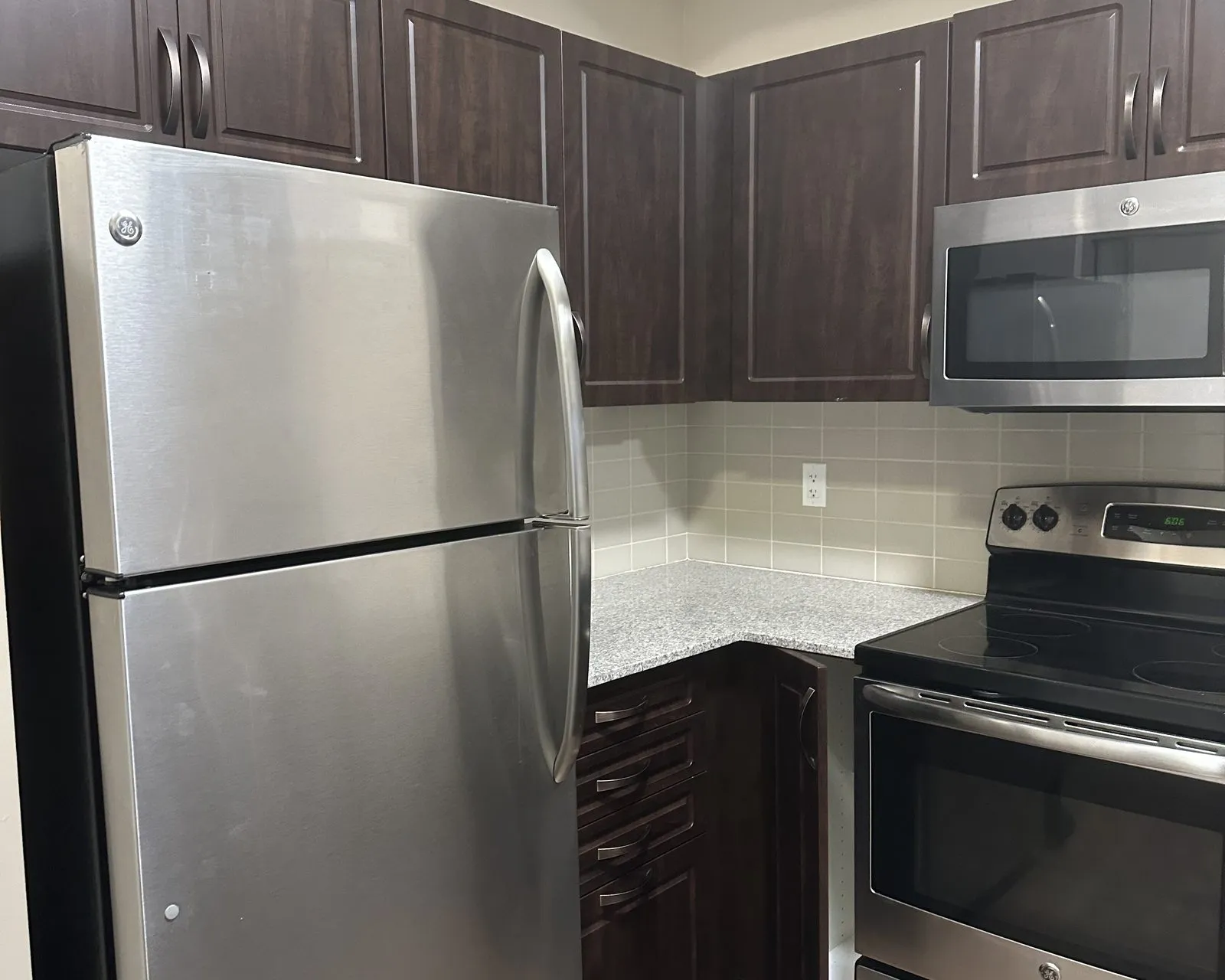 Before — espresso thermofoil to Cashmere Grey, refaced and sprayed to match — Markham Village, Markham