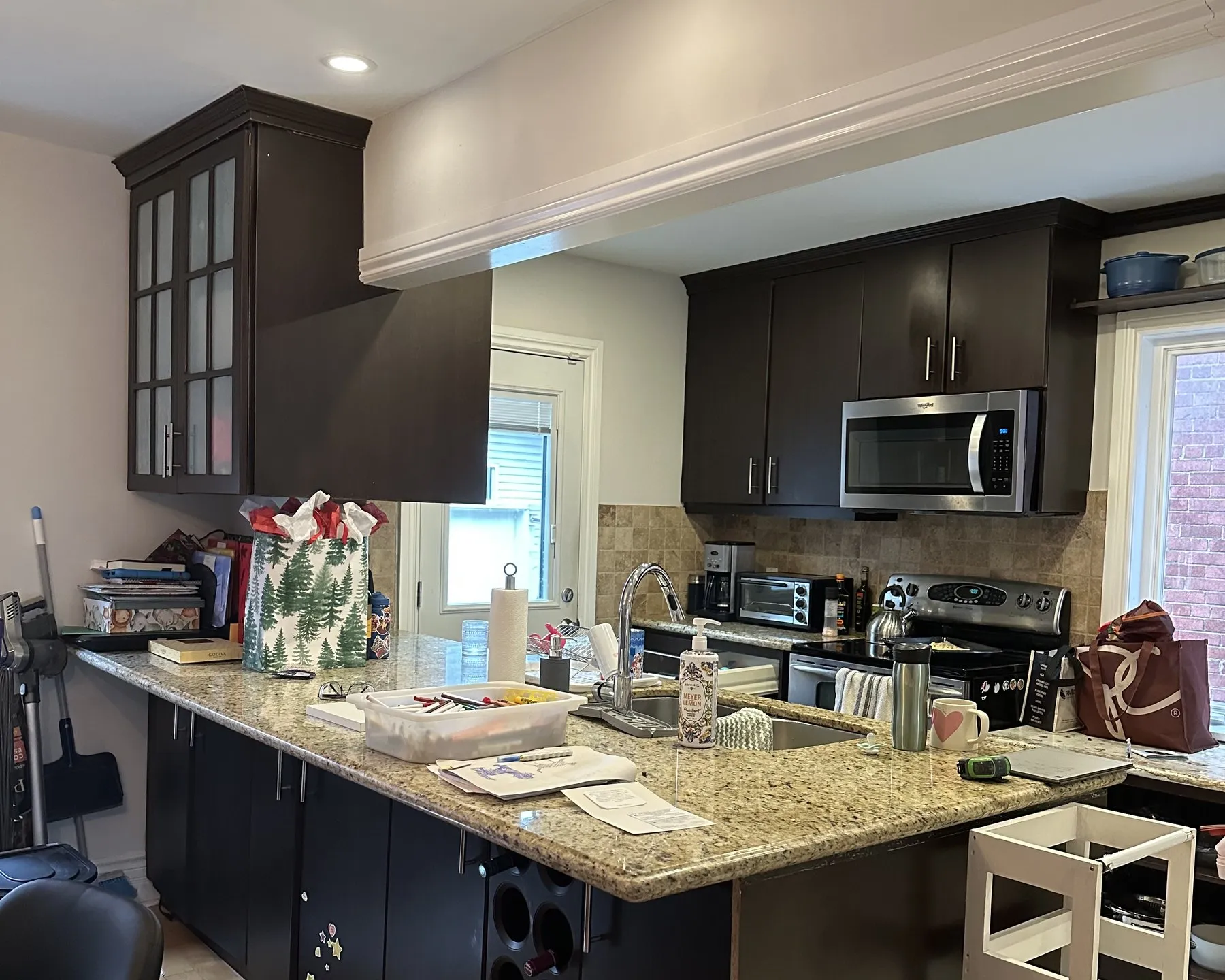 Before — espresso to white shaker, granite kept in College Park, Oakville